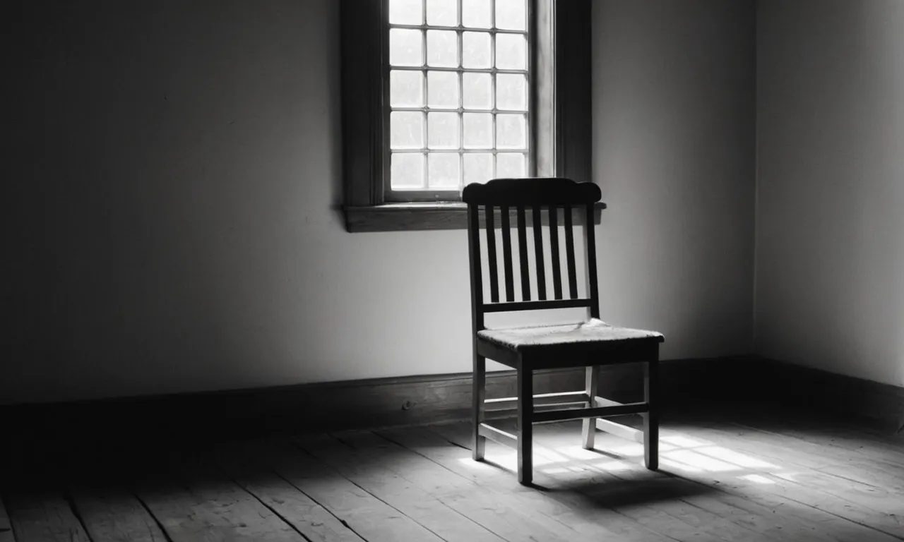 A black and white photo captures a dimly lit room, showing a worn-out wooden chair symbolizing patience, as sunlight filters through a small window, illuminating a bible resting on the seat.