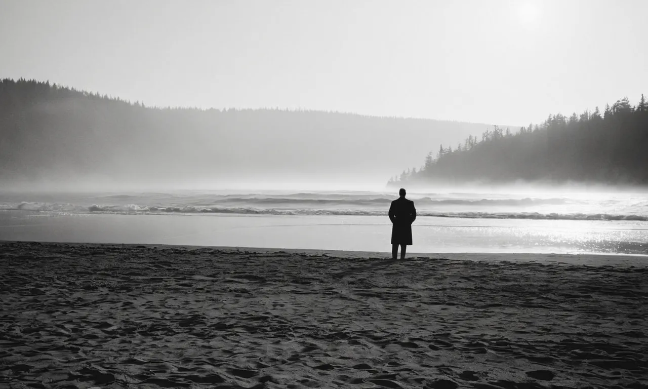 A black and white photo of a solitary figure standing on a misty shoreline, gazing towards the horizon, hinting at the anticipation and mystery surrounding Jesus' knowledge of his return.