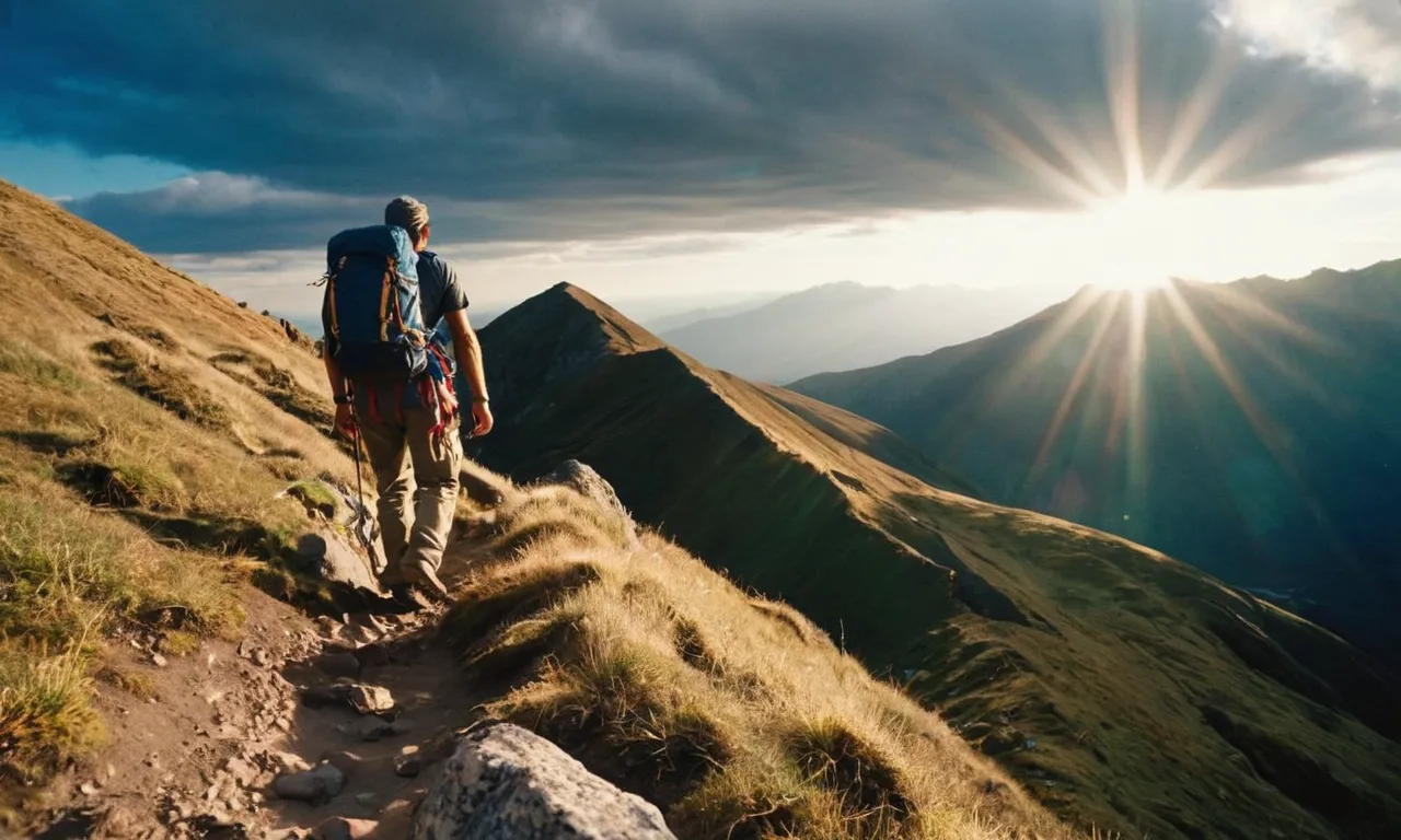 A photo captures a weary traveler climbing a steep mountain, with a divine ray of light shining upon him, symbolizing how God empowers those who strive towards their goals.