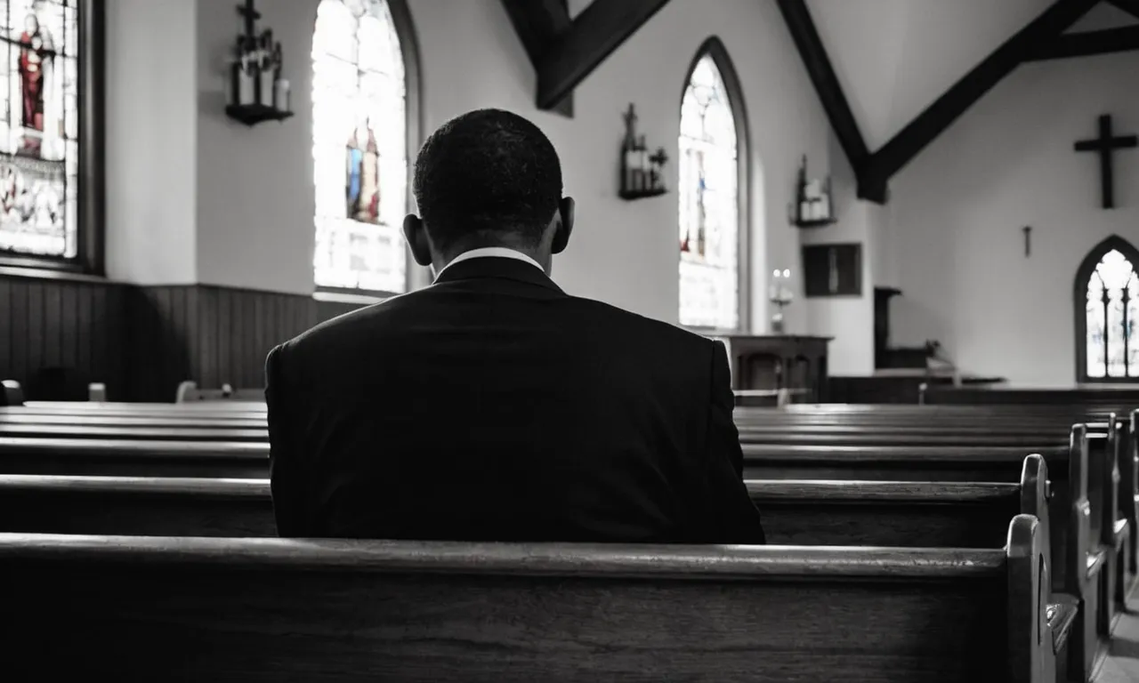 A black and white image capturing a person sitting alone in a dimly lit church pew, their head bowed in contemplation, conveying a sense of doubt and questioning towards religion.