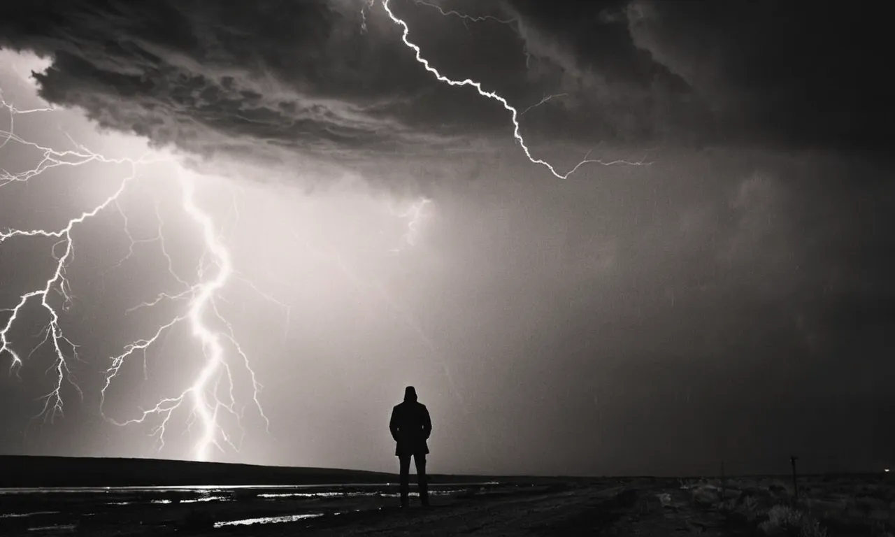 A powerful black and white image captures a solitary figure standing tall amidst a storm, with lightning illuminating the sky, symbolizing divine justice and the promise of retribution for those who have caused harm.