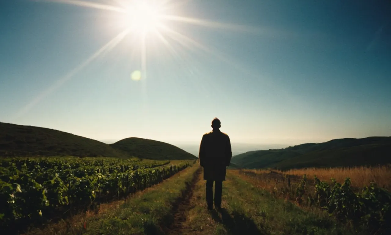 A breathtaking image captures a person standing in a ray of sunlight, surrounded by darkness. Symbolizing their transformative journey, as God's divine light illuminates their path, guiding them through life's challenges.