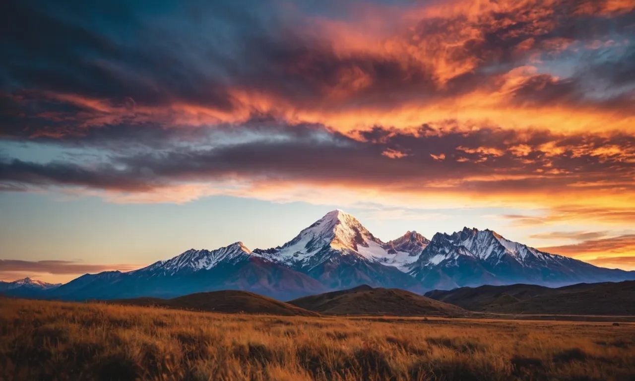 A breathtaking photo capturing a vibrant sunset behind a majestic mountain range, symbolizing the awe-inspiring greatness of God's creation.