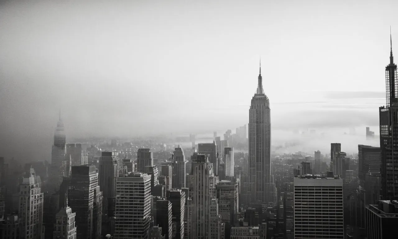 A black and white photograph capturing the towering Empire State Building, slightly obscured by wisps of fog, symbolizing the mystery and uncertainty of its longevity.