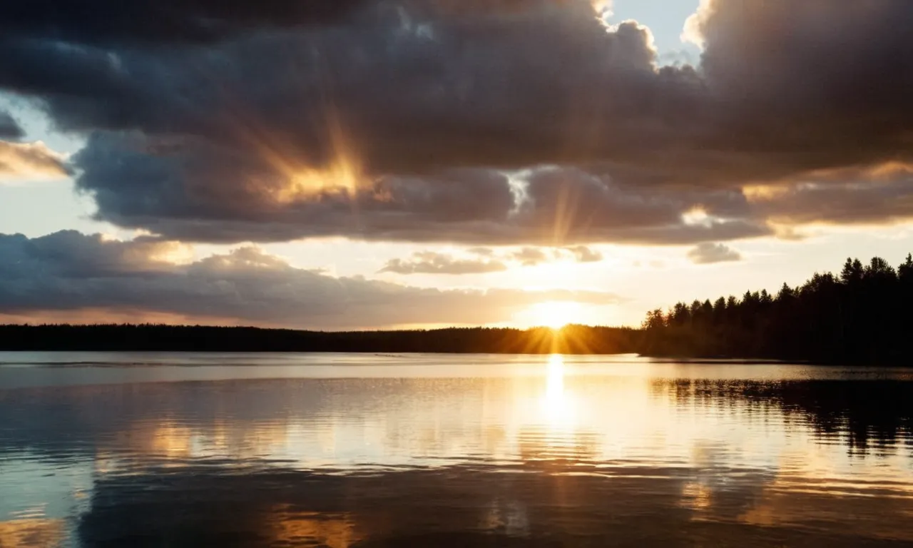 A captivating photo capturing a sunset over a serene lake, with rays of light beaming through the clouds, symbolizing the countless miracles Jesus performed during his time on Earth.