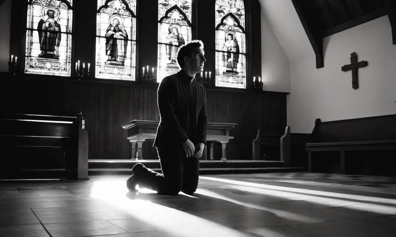 A black and white photo of a person kneeling in a church, with a beam of sunlight shining through a stained glass window, illuminating their face as they listen intently.
