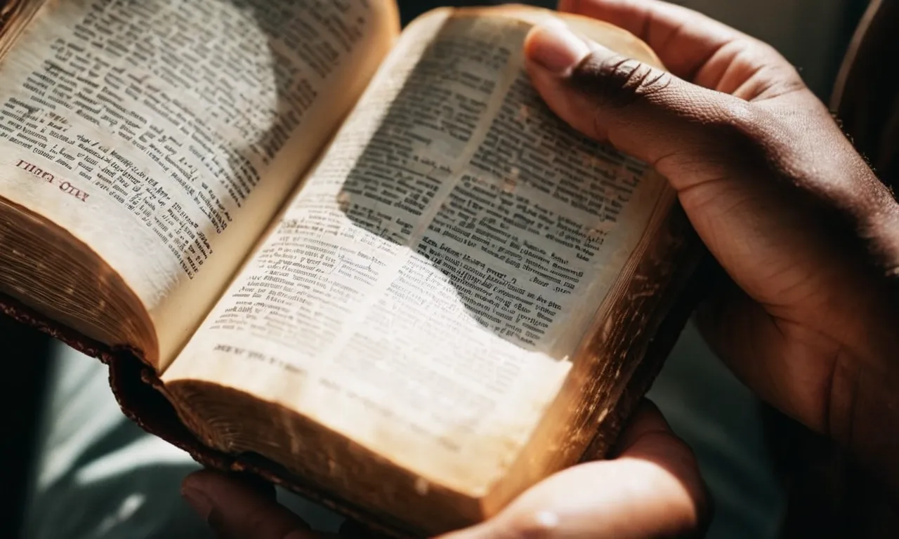 A close-up photo of a person's hands holding a worn Bible, with rays of sunlight streaming through the pages, symbolizing an intimate connection with Jesus through scripture.