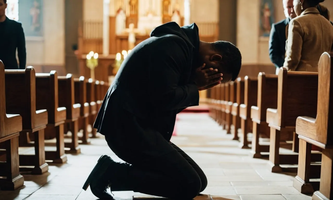 A photo capturing a person kneeling in a dimly lit church, tears streaming down their face, as they fervently clasp their hands in prayer, seeking to rededicate their life to God.