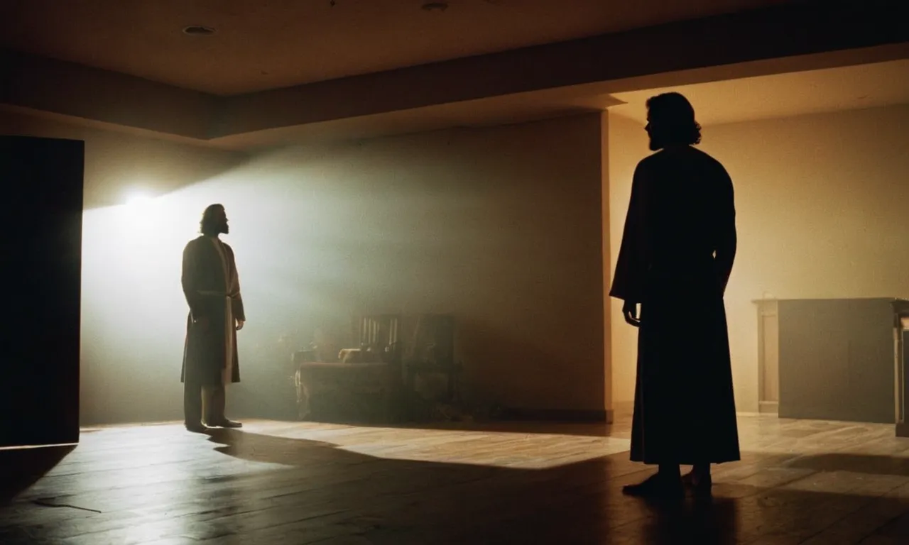 A photograph showcasing a silhouette of a person standing in a dimly lit room, with a faint beam of light falling on them, symbolizing Jesus as a source of hope in times of despair.