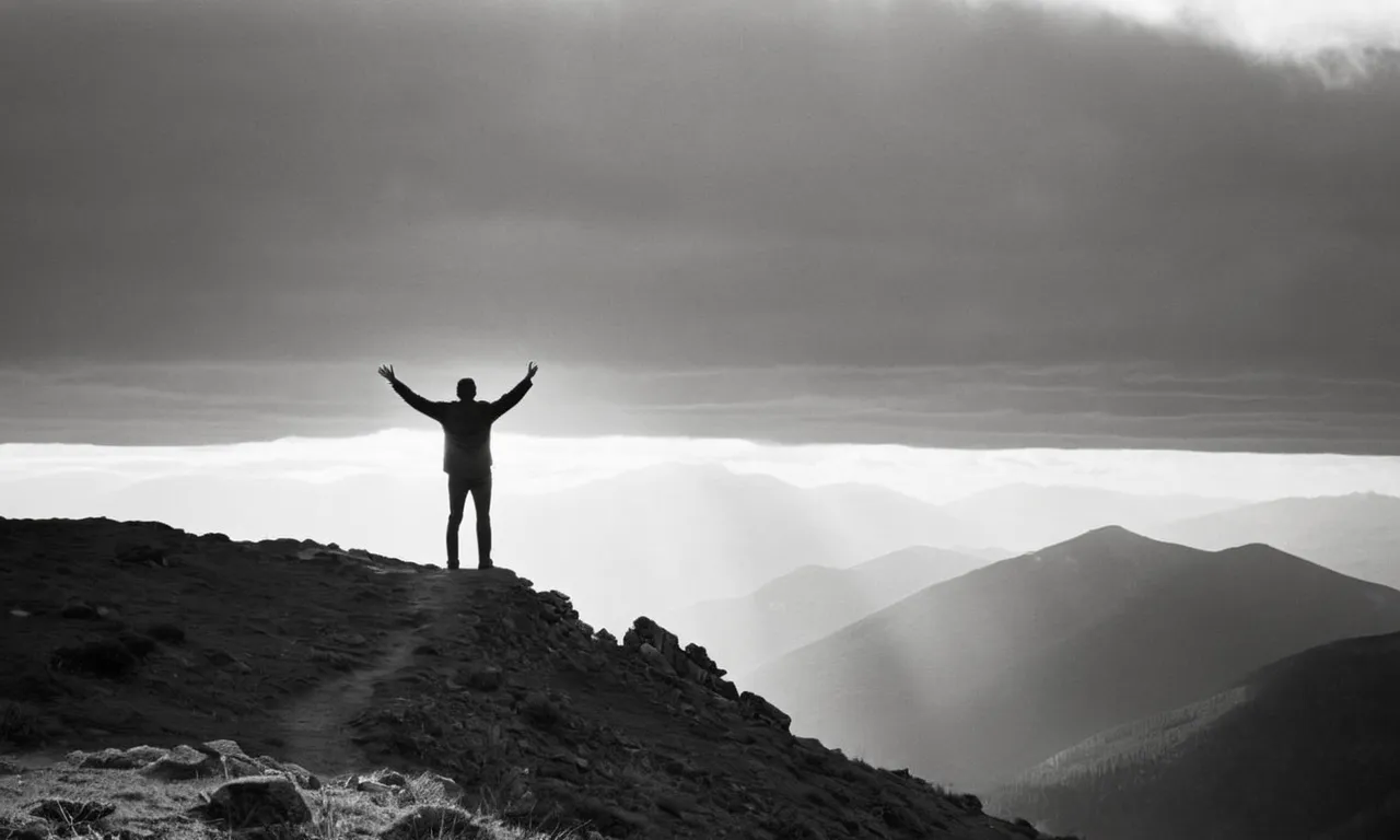 A black and white photograph captures a solitary figure standing on a mountaintop, their outstretched arms reaching towards the heavens, symbolizing the presence of the god who hears.