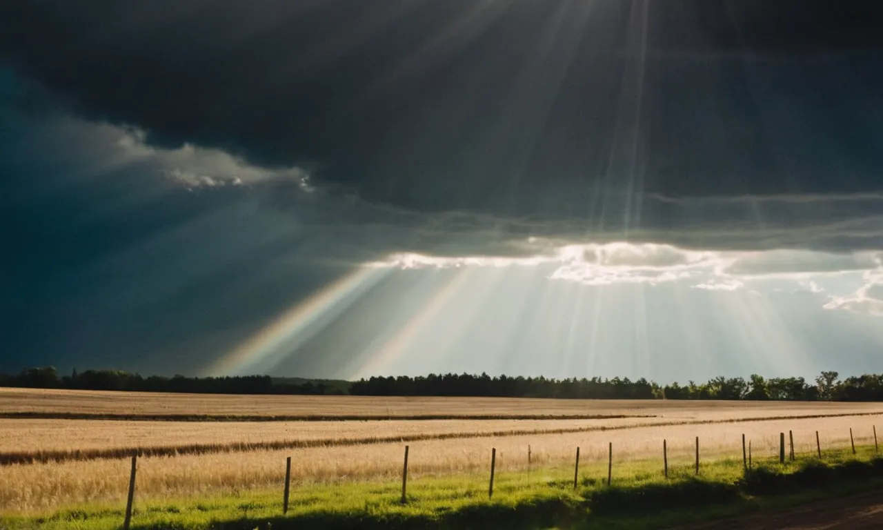 A photo depicting a serene landscape, with rays of sunlight breaking through dark clouds, symbolizing God's omnipresence, transcendence, and benevolence.