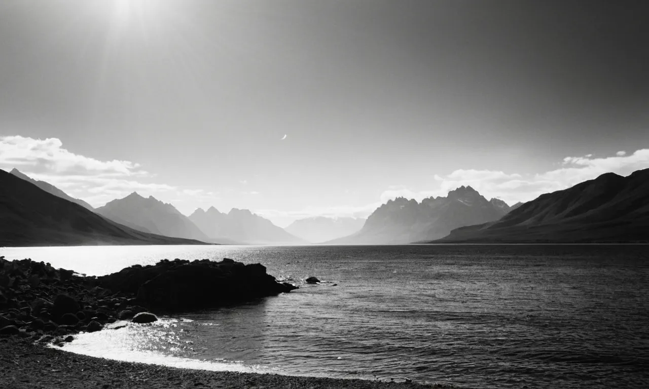 A captivating black and white image showcasing a serene landscape with four distinct elements - earth, air, water, and fire - symbolizing the 4 omnis of God.