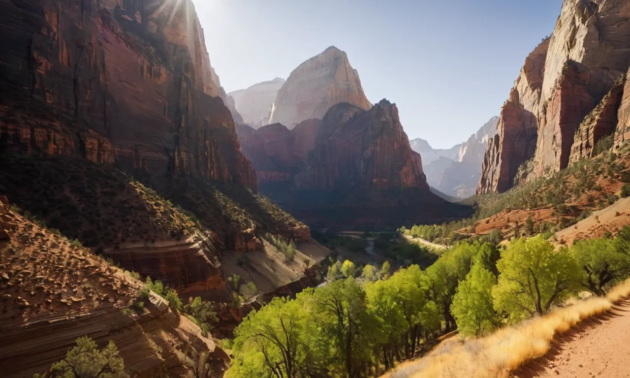 A photo showcasing a majestic mountain landscape, with the sun's rays streaming through a narrow, towering canyon, symbolizing the awe-inspiring Gates of Zion mentioned in the Bible.