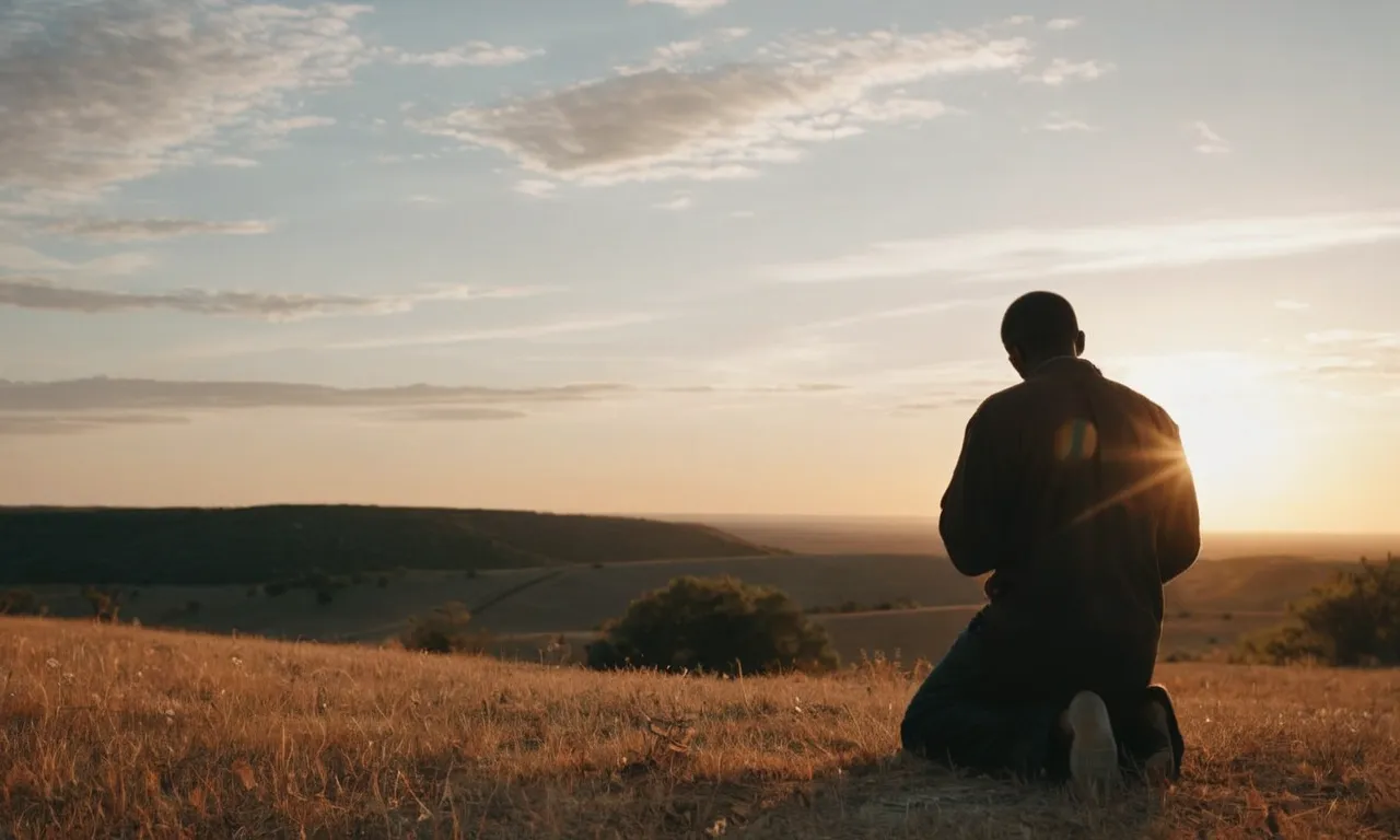 A photograph capturing a serene sunset, with a solitary figure kneeling in prayer, symbolizing the three laws of God: love, faith, and obedience.