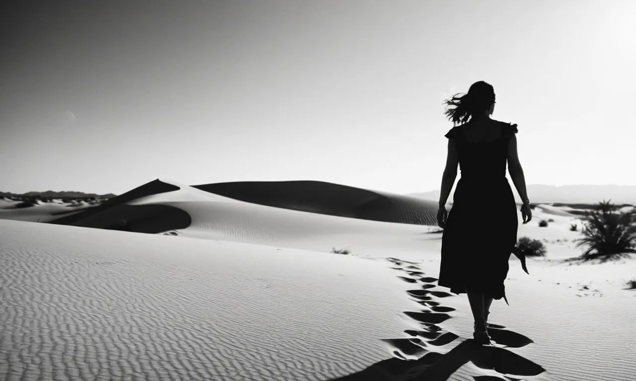 A black and white photo capturing a silhouette of a woman walking through a desert, symbolizing Hagar's resilience and strength in navigating life's challenges.