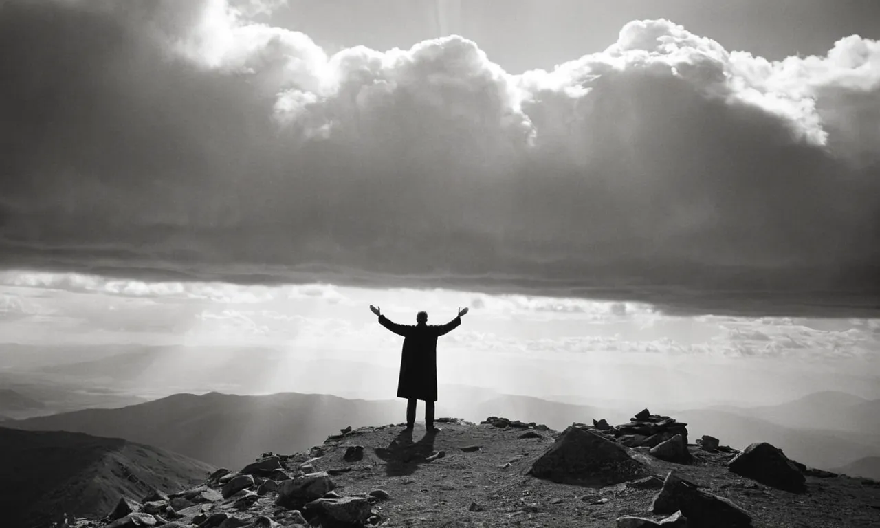 A black and white image capturing a solitary figure standing on a mountaintop, their outstretched arms reaching towards the heavens, symbolizing Abraham's divine call and his unwavering faith.