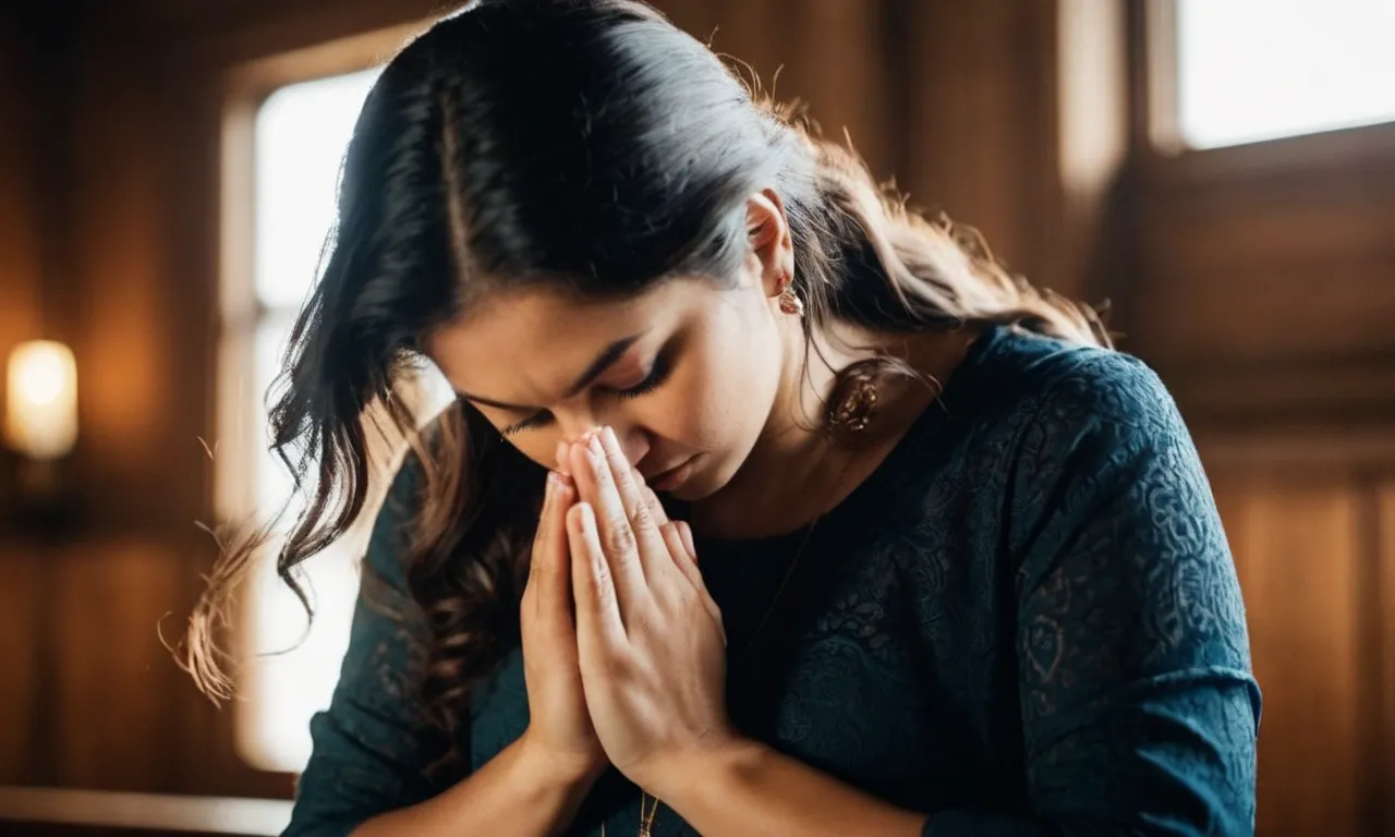 A photo capturing a person, immersed in prayer with closed eyes and folded hands, depicting the compelling nature of faith as described in the Bible.