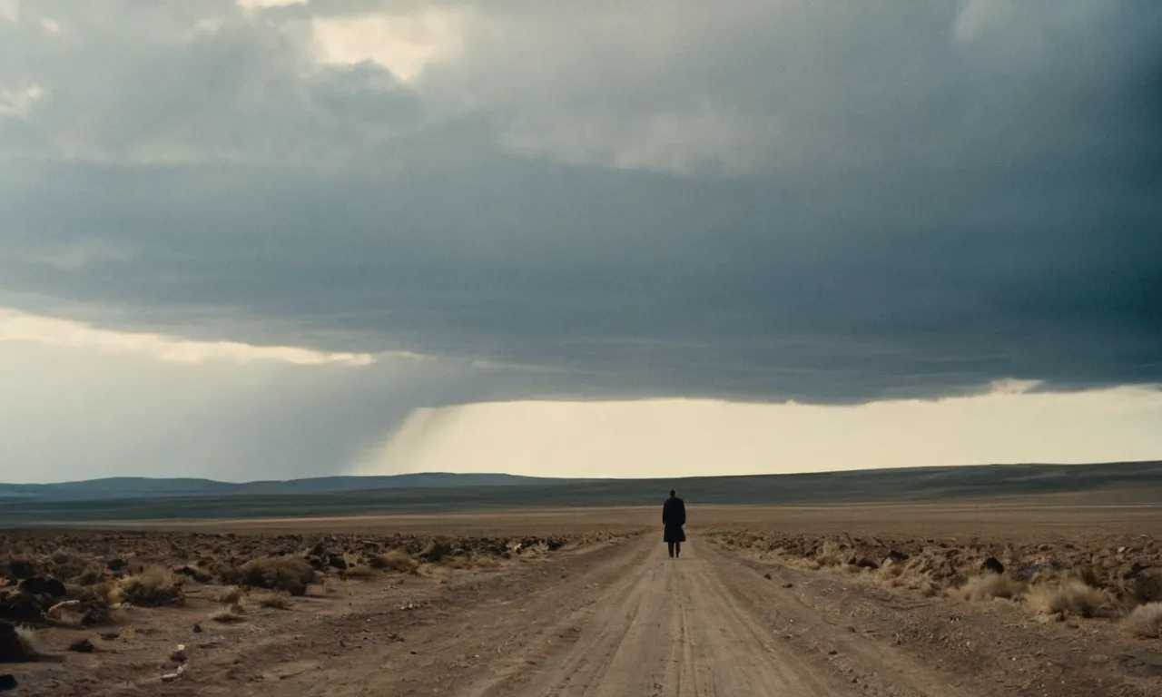 A photo depicting a desolate landscape with a lone figure standing at the edge, symbolizing the biblical concept of exile, conveying a sense of isolation, displacement, and longing for home.