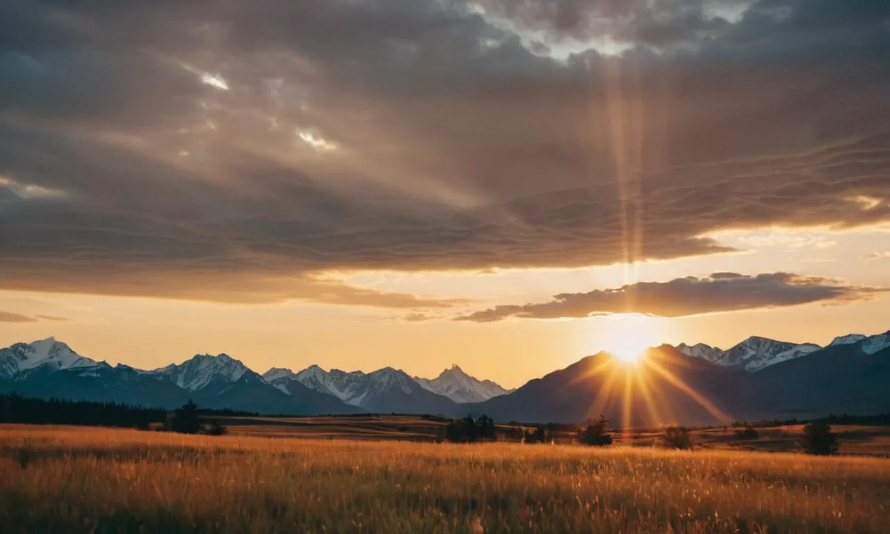 A photo capturing a serene sunset over a mountain range, where the golden rays of light symbolize God's grace and the awe-inspiring beauty of nature.