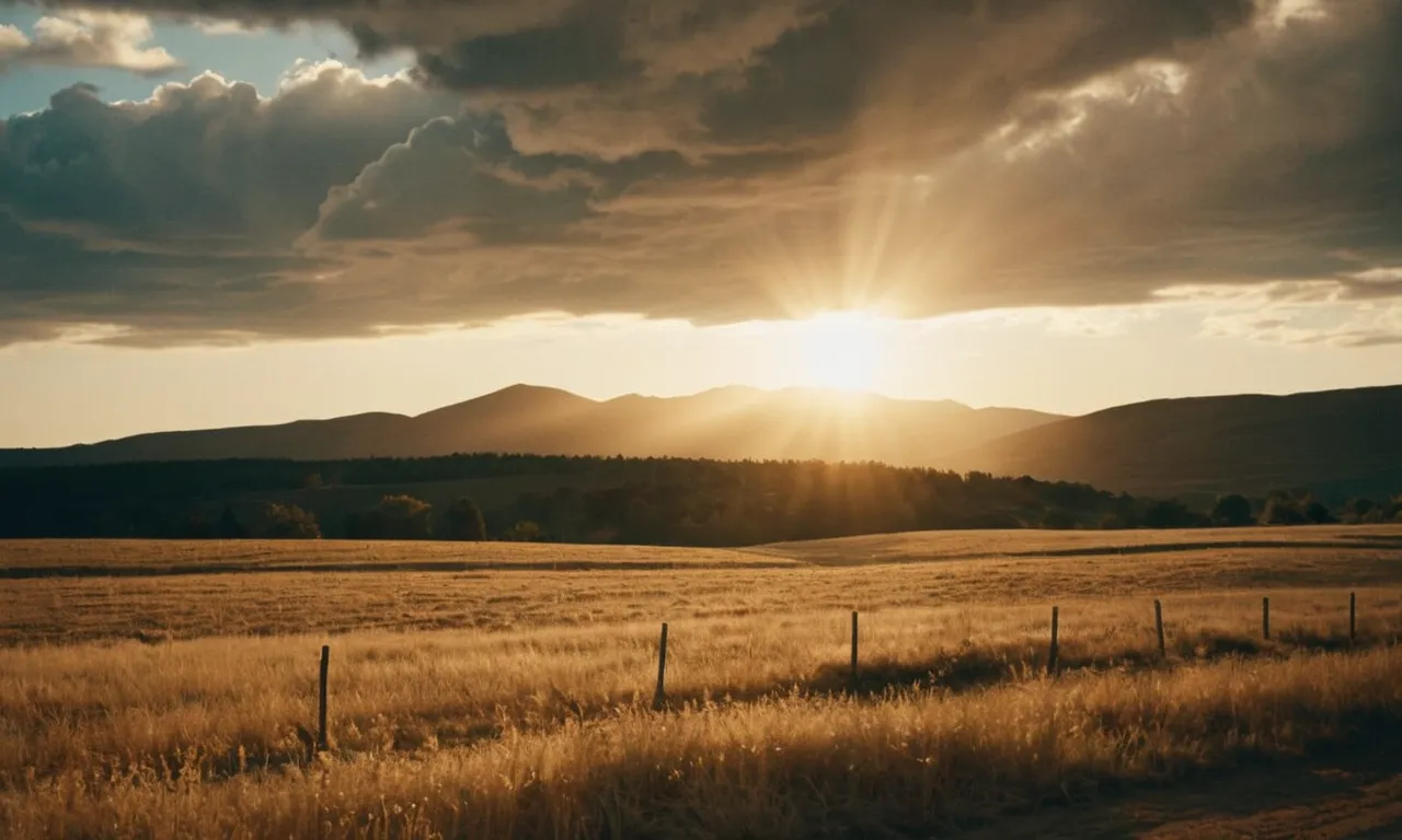 A captivating image showcasing a serene landscape where golden sunlight filters through majestic clouds, creating a heavenly glow, leaving viewers pondering the answer to "What does God look like in real life?"