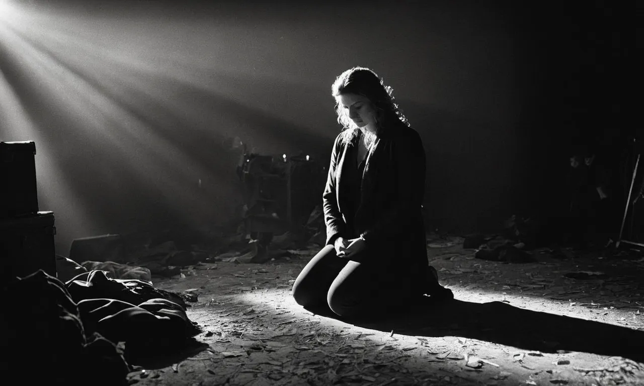 A serene black and white image shows a person kneeling amidst chaos, their tear-streaked face illuminated by a single ray of light, conveying the vulnerability and longing for divine acceptance.