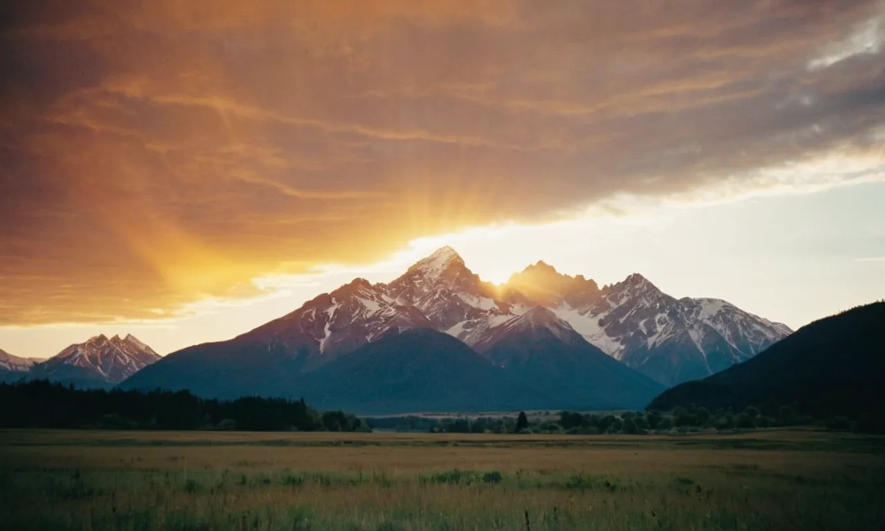 A photo capturing a serene sunrise over a mountain range, symbolizing God's unwavering faithfulness and the steadfastness of His promises as described in the Bible.