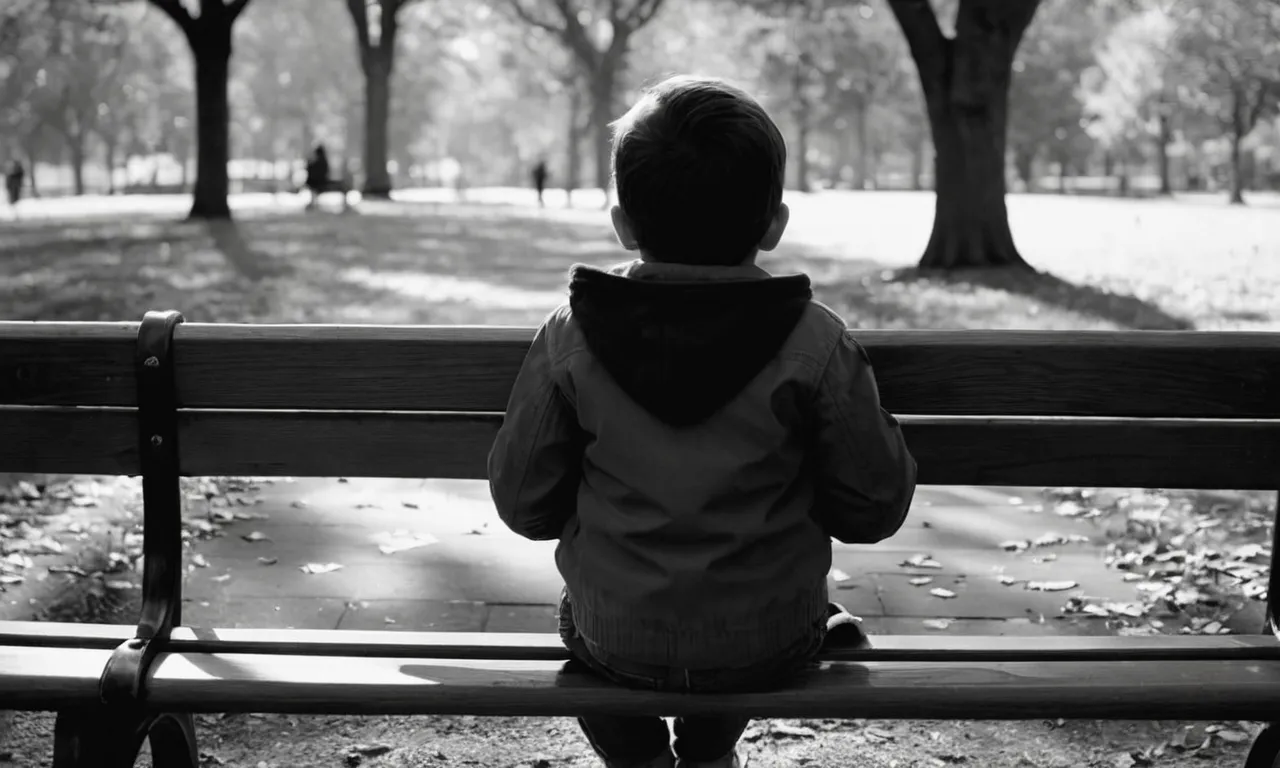 A black and white photo captures a child sitting alone on a park bench, looking up at an empty space beside them, symbolizing the void left by an absent father.