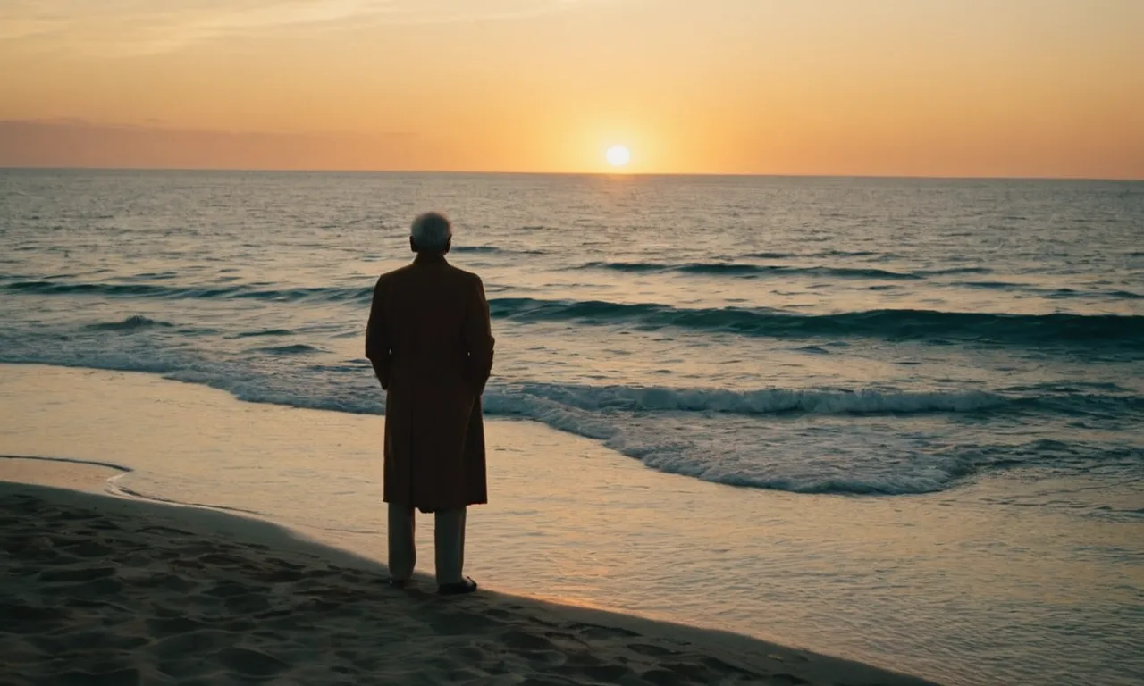 A captivating photo depicting a solitary figure standing at the edge of a vast ocean, bathed in the warm hues of a setting sun, symbolizing trust and patience in God's perfect timing.