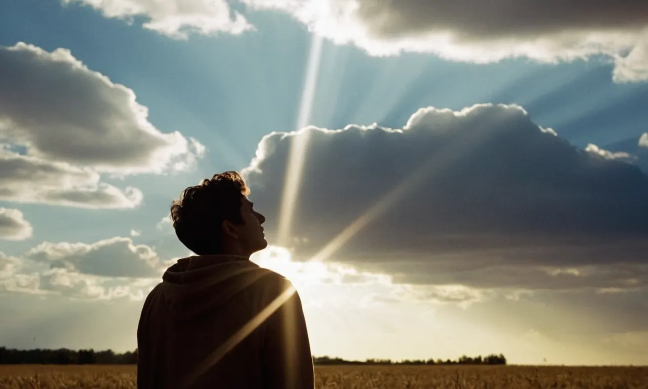 A photo capturing a person in solitude, looking up with a hopeful expression, as rays of sunlight pierce through the clouds, symbolizing the divine moment of hearing one's name called by God.