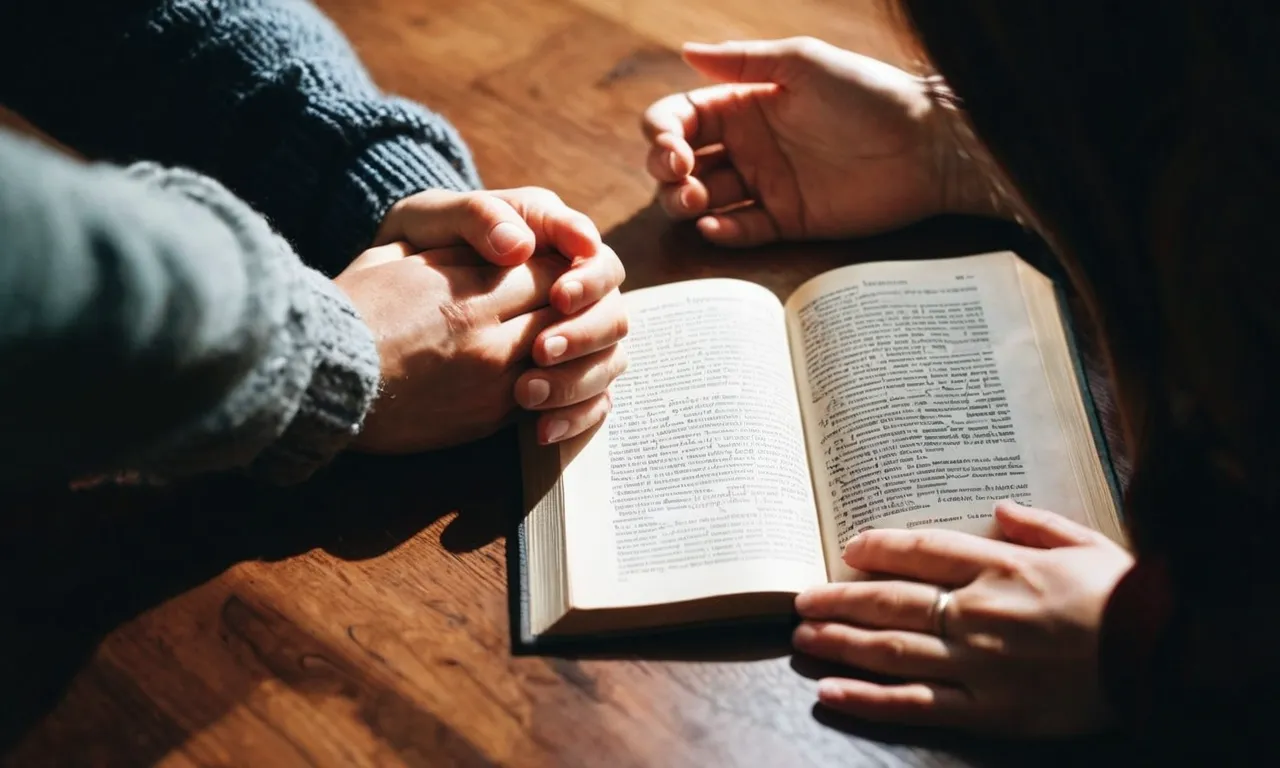 A photo capturing a couple holding hands, heads bowed in prayer, next to an open Bible, highlighting the emotional struggle and seeking solace in faith amidst the topic of infertility.