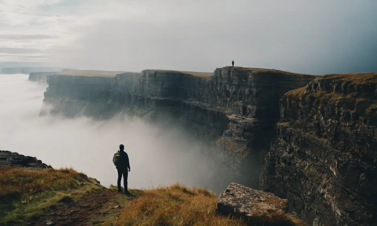 A powerful photo capturing a person standing at the edge of a foggy cliff, symbolizing the uncertainty of moving forward, while holding a Bible tightly, signifying faith and guidance.
