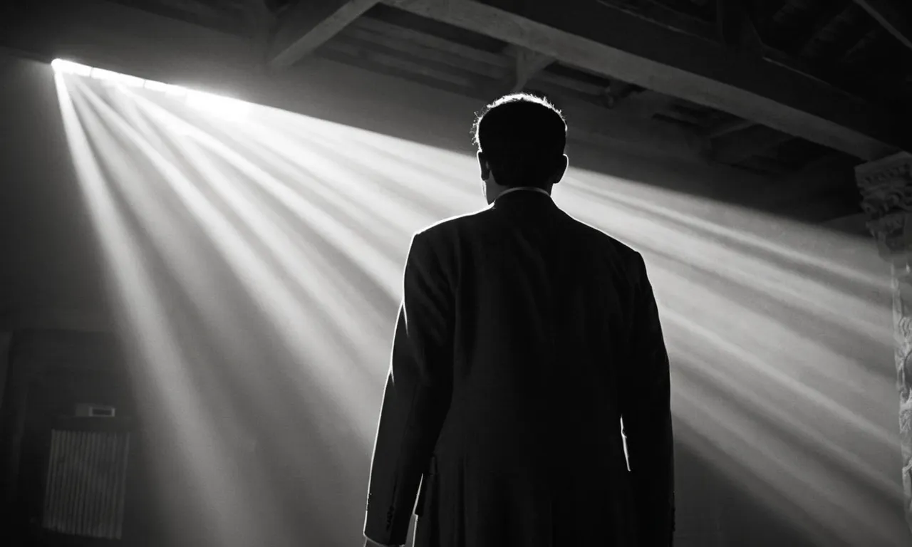 A powerful black and white image captures a person standing tall amidst adversity, their face illuminated by a beam of light, symbolizing the Bible's encouragement to stand up for oneself with courage and faith.