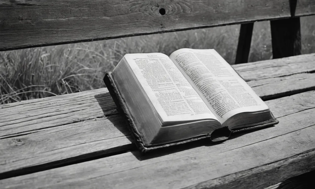 A black and white photo capturing a solitary Bible resting on a weathered wooden bench, symbolizing the divide between believers and unbelievers, provoking contemplation and reflection.