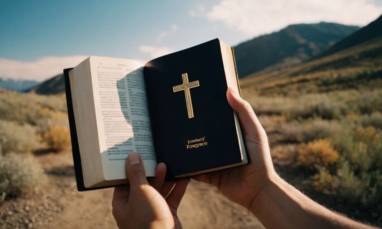 A photo of a person holding a Bible, with their hand covering a word that represents unforgiveness, symbolizing the power of forgiveness and the need to let go of resentment.