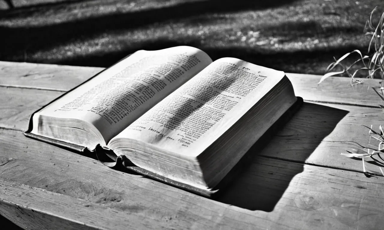 A black and white photograph capturing an aged, worn Bible, open to the book of Genesis, with a beam of soft sunlight illuminating the page, highlighting the word "ye."
