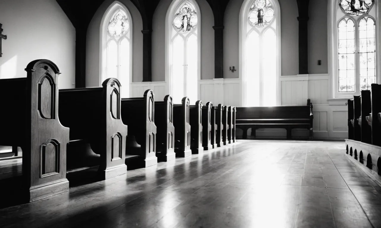 A black and white photo captures an empty church pew, bathed in a soft ray of sunlight, symbolizing the absence of God and questioning what has become of our faith.