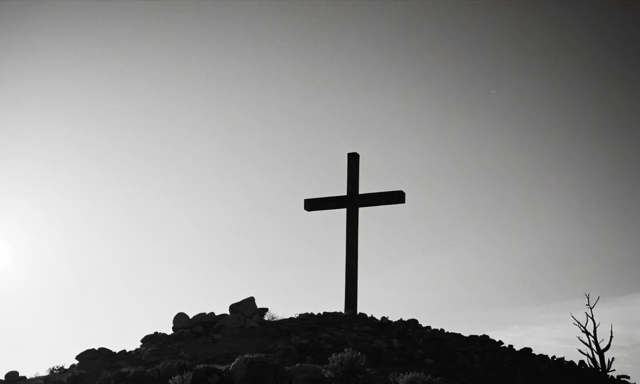 A hauntingly breathtaking black and white photo captures the somber silhouette of a lone cross atop a rugged hill, evoking the profound question of where Jesus was crucified.