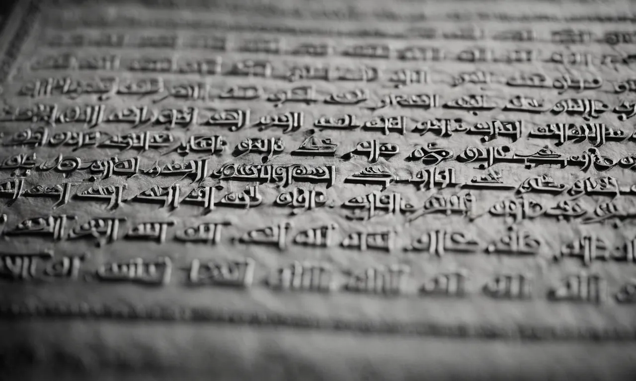 A black and white close-up photograph of an ancient Aramaic manuscript, showcasing beautifully engraved text that reads "What is God?" in delicate calligraphy.