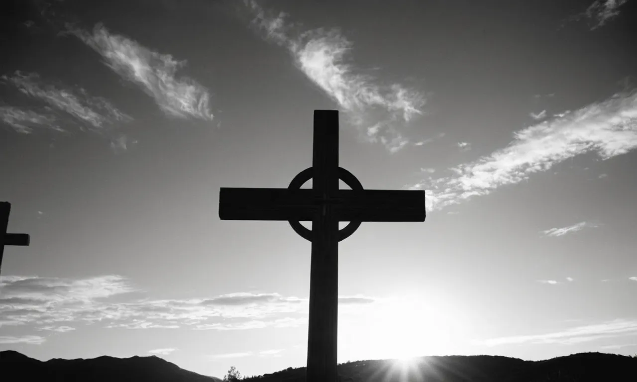 A black and white photograph captures an empty wooden cross against a serene sunset backdrop, symbolizing the immeasurable spiritual wealth and sacrifice of Jesus rather than worldly possessions.