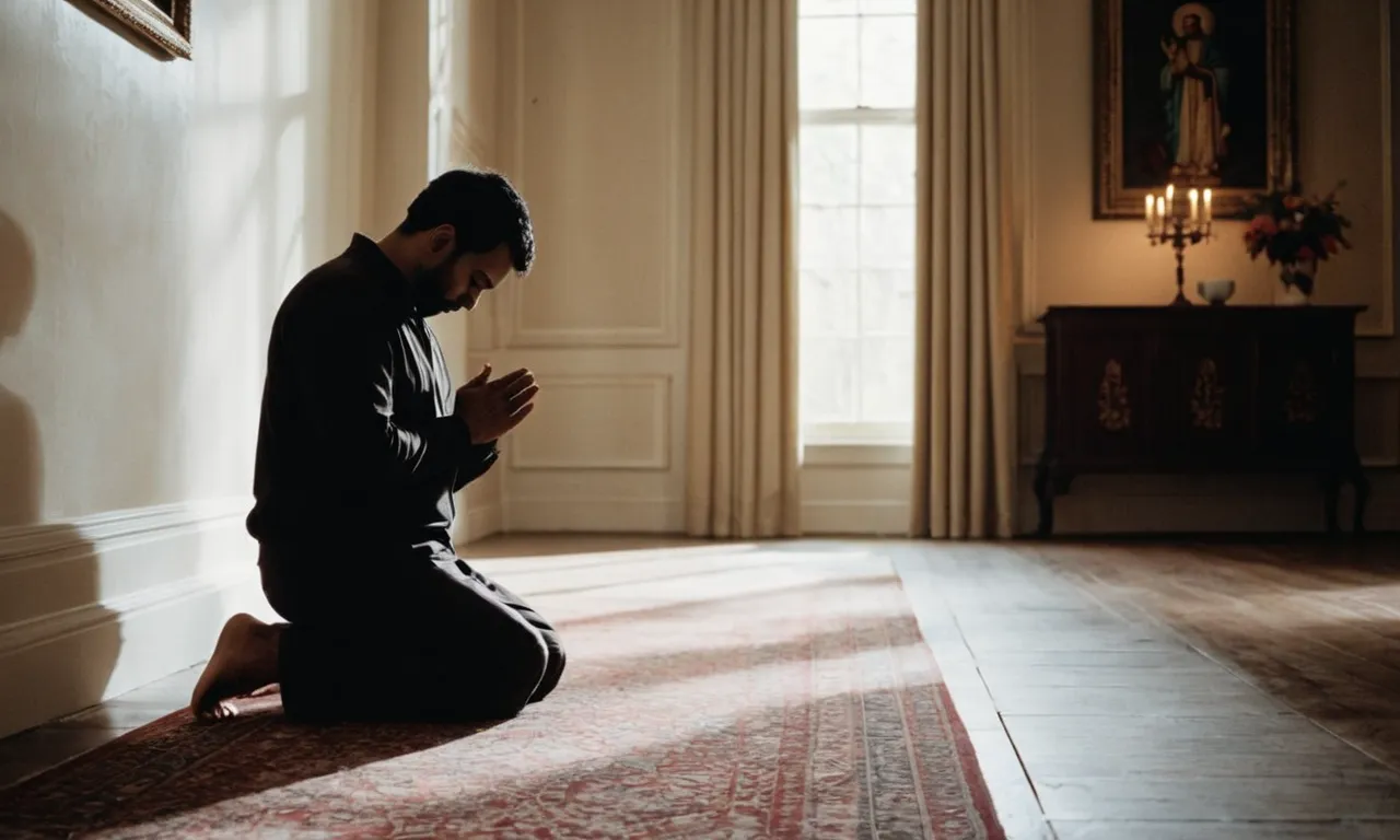 A black and white photograph captures a solitary figure kneeling in a dimly lit room, their hands clasped in prayer, conveying the essence of the fear of the Lord through reverence and awe.