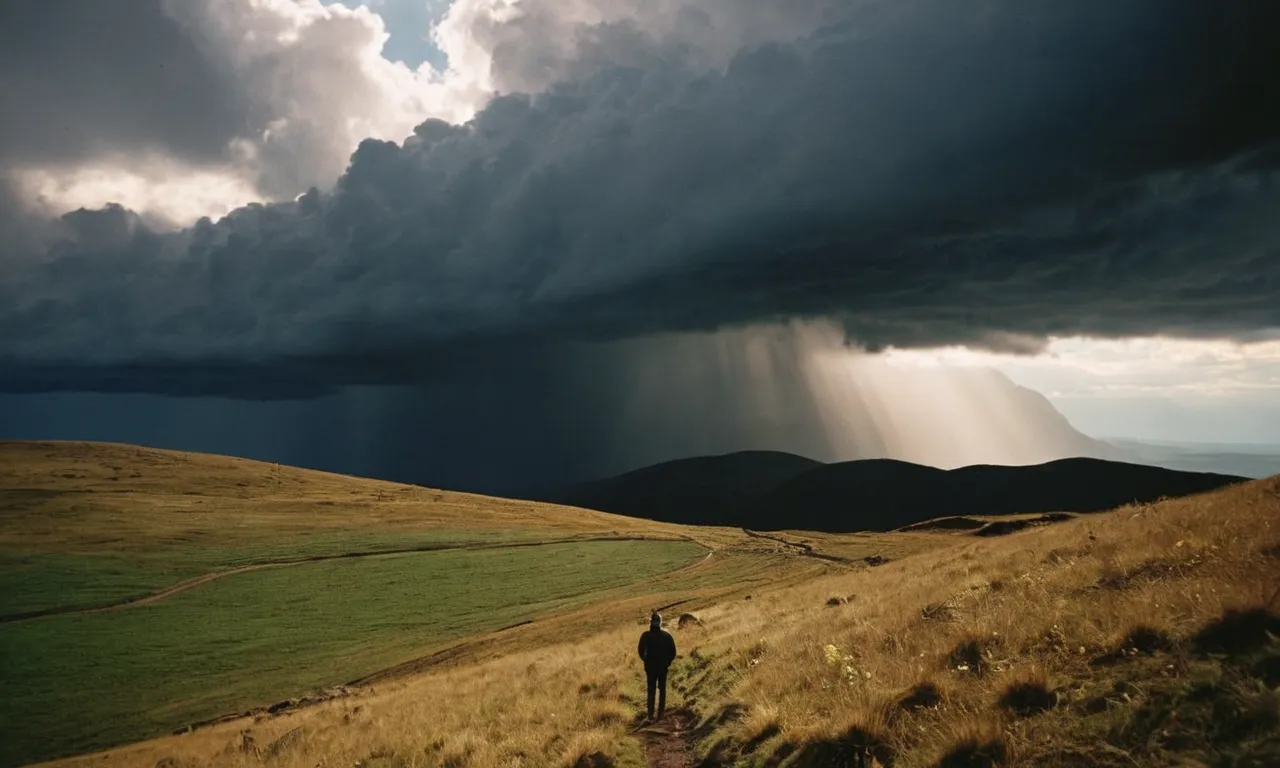 A breathtaking landscape shot captures the sun's rays piercing through dark storm clouds, illuminating a lone figure standing on a mountaintop, evoking a palpable sense of divine intervention.