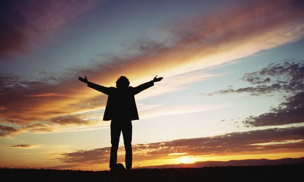 A captivating photo of a person standing with arms outstretched against a vivid sunset, their silhouette illuminated by a ray of light, reminiscent of the iconic pose associated with the "Jesus shot."