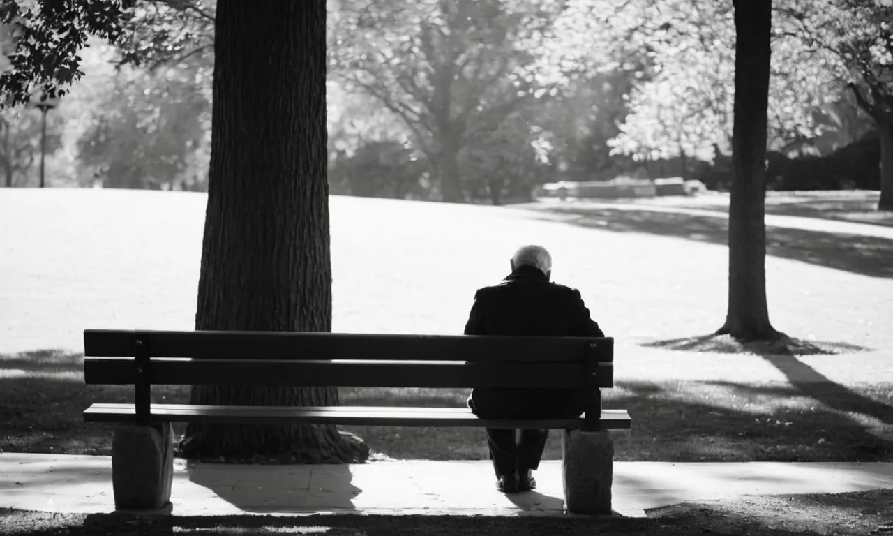 A black and white photo of a solitary figure sitting on a park bench, their head bowed in contemplation, surrounded by empty spaces and long shadows, symbolizing the patience and introspection required while waiting on God.