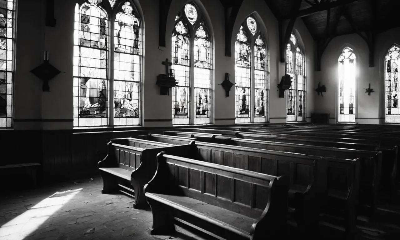 A captivating black and white image of a desolate church, sunlight piercing through broken stained glass, symbolizing the silence and abandonment felt by man when God ceased communication.