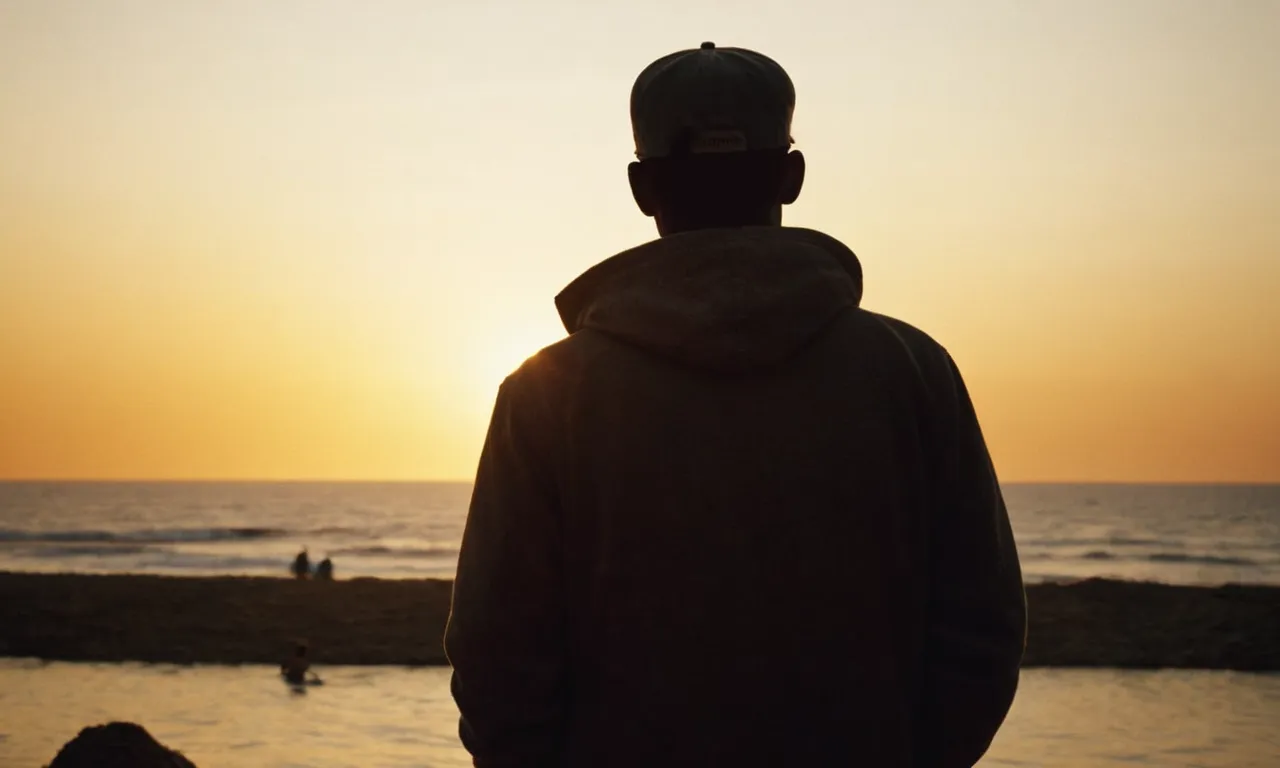 A solitary figure stands silhouetted against a golden sunset, their back turned to a crowd, symbolizing the isolation and separation that accompanies a divine assignment on one's life.
