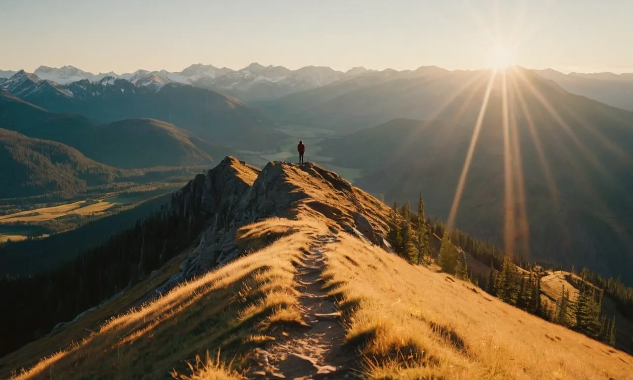 A captivating shot captures a person standing on a mountaintop, bathed in golden sunlight, symbolizing their spiritual journey as they reach the pinnacle of success and divine elevation.