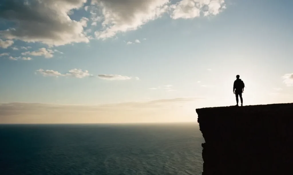 A silhouette of a person standing at the edge of a cliff, staring into the vast unknown, symbolizing the discomfort before taking a leap of faith into a new chapter.