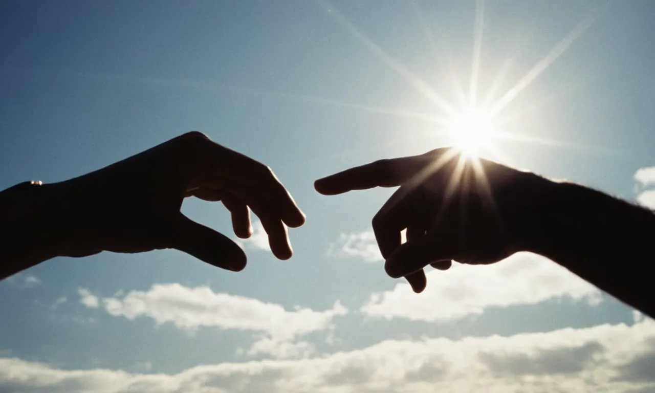 A black and white image captures two hands reaching out towards each other, but a divine light shines between them, symbolizing the moment when God separates two souls destined to part ways.