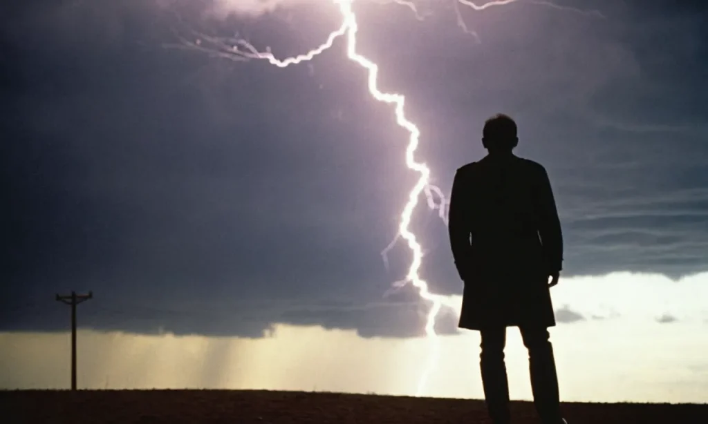 A monochromatic image of a solitary figure, their face partially obscured by shadow, as a bolt of lightning ominously splits the sky behind them, serving as God's cautionary message.