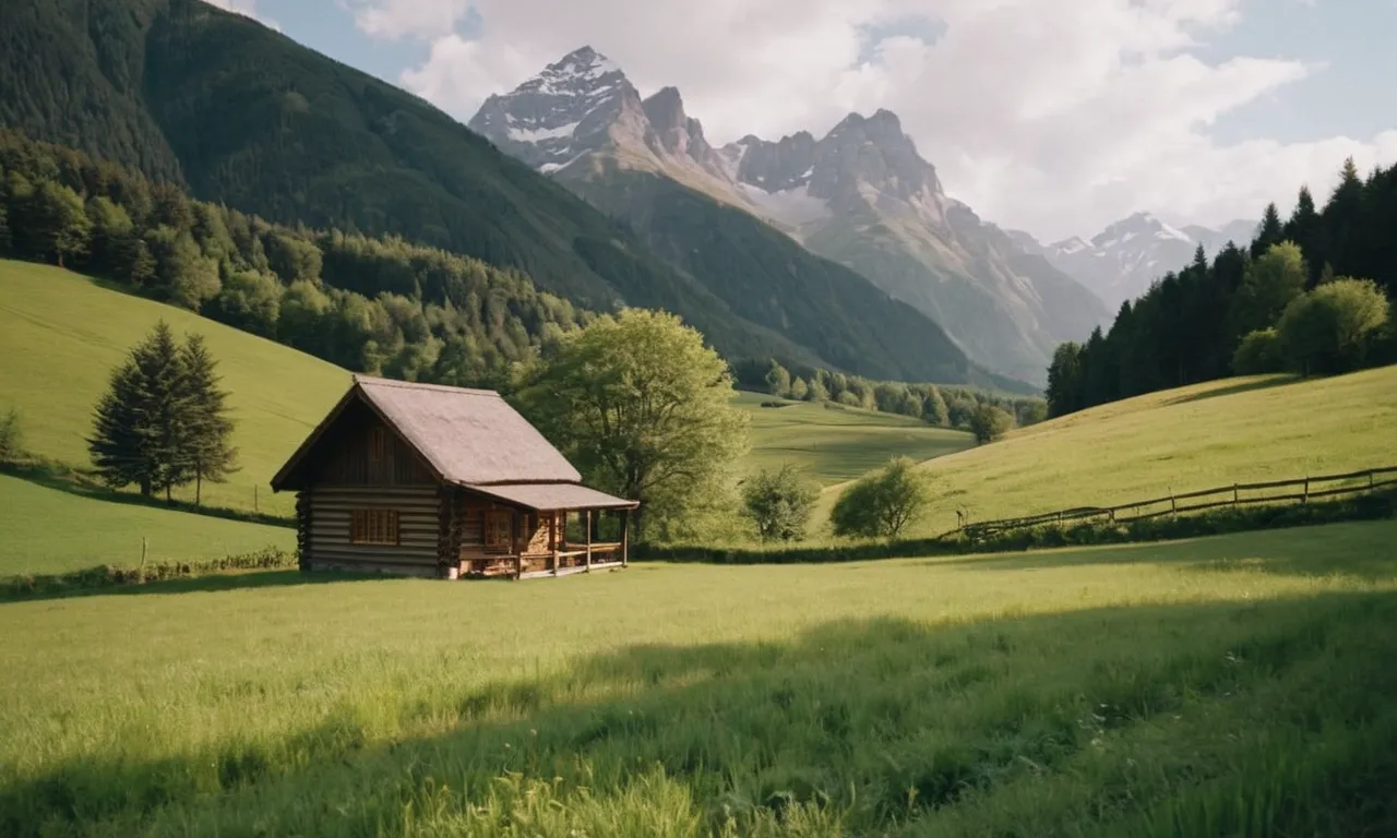 A photo capturing a serene countryside with a small cabin nestled amidst lush green fields, surrounded by towering mountains, evoking a sense of peace and divine guidance in choosing the perfect place to reside.
